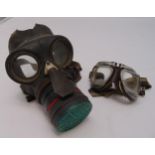 WWII gas mask and a pair of vintage motor cycle goggles