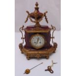 A French gilded metal and porcelain oval mantle clock, white enamel dial with Arabic numerals,