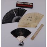 Three decorative antique fans, one with lacquered case, A/F