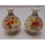 A pair of Royal Worcester blush ivory vases of baluster form decorated with flowers and leaves on