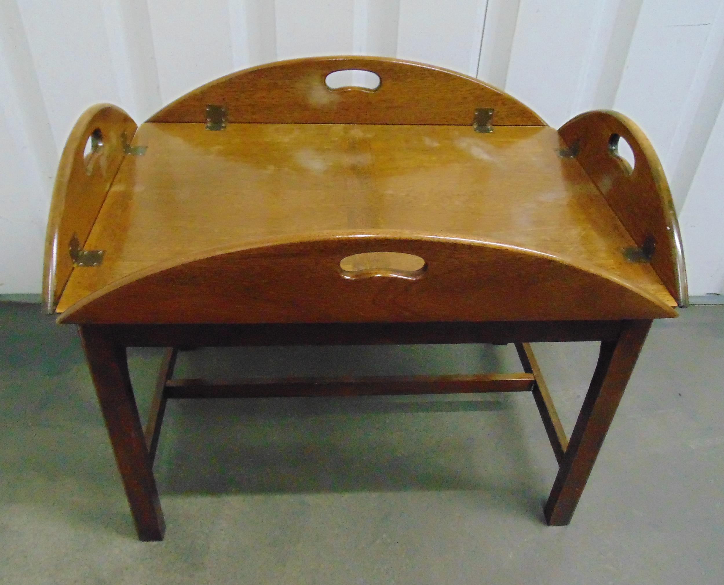 A rectangular mahogany butlers tray of customary form with hinged sides on stand, 45.5 x 90 x 70.