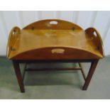 A rectangular mahogany butlers tray of customary form with hinged sides on stand, 45.5 x 90 x 70.