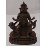 A gilded bronze Buddha seated on a lion on raised oval base, 23cm (h)