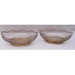 A pair of Walker and Hall hallmarked silver wirework oval roll baskets on raised oval bases,