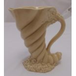 A Clarice Cliff Cornucopia jug with scroll handle on shell and mollusc base, marks to the base, 25cm