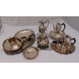 A quantity of silver plate to include a teaset, a water jug, a chaffing dish, trays and condiments