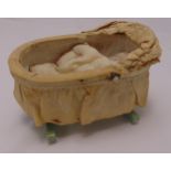 An early 20th century childs play crib with wind up musical movement, 13 x 24 cm