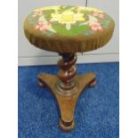 A Victorian rise and fall piano stool with barley twist column on triform base with embroided