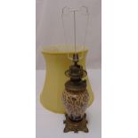 A Victorian oil lamp with baluster ceramic body on raised square base with shell feet, converted