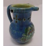 A Victorian salt glazed ceramic puzzle jug decorated with flowers, leaves and inscription, signed