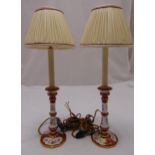 A pair of porcelain table lamps, knopped cylindrical form on raised circular bases with silk shades,