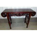 A Chinese hardwood rectangular hall table, profusely carved on four shaped rectangular legs, 83 x