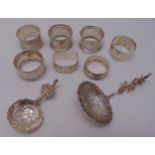 A quantity of silver and white metal to include seven napkin rings and two caddy spoons, approx