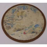 A framed circular Chinese silk work panel decorated with exotic birds and vegetation, 25cm (d)