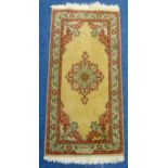 A Middle Eastern rectangular wool carpet, central rosettes within floral border predominately