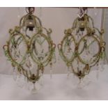 A pair of Murano crystal and metal chandeliers of faceted oval form with faceted pendant drops, 75cm