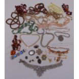 A quantity of costume jewellery to include necklaces, brooches and a bangle