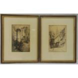 Two framed and glazed monochromatic etchings by Featherstone Robson of buildings in a cityscape,