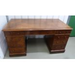 An early 20th century rectangular mahogany pedestal desk, the drawers with turned wooden handles and