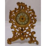 A gilded metal desk clock in Rococo style frame with white enamel chapter ring and Arabic