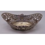 A continental white metal oval roll basket with pierced side, chased with floral swags and