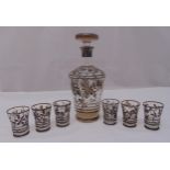 A continental Art Deco decanter with drop stopper and six matching shot glasses