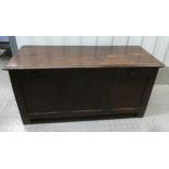 An antique oak lead lined coffer, panelled sides, hinged top on four bracket feet, 66 x 138 x 56cmn
