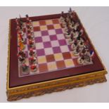 A 20th century polychromatic composition chess set, the figures in Napoleonic uniform in fitted case