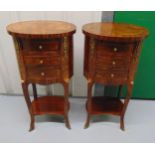 A pair of mahogany and Kingswood oval side tables, brass mounts, three drawers on four cabriole