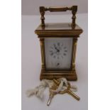 A L'pee France miniature brass carriage clock of customary form with white enamel dial, Roman