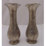 A pair of Art Nouveau style pewter vases, pear shaped chased with flowers on raised circular