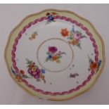 A Meissen style plate decorated with spays of flowers, crossed sword marks to the base, 22cm (d) A/