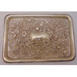 A hallmarked silver dressing table tray, rounded rectangular chased with flowers and leaves, Chester