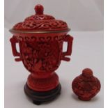 A cinnabar lacquer vase and cover craved with flowers and leaves, the domed pull off cover with