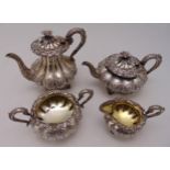 A George IV hallmarked silver four piece tea and coffee set of compressed, lobed spherical form,