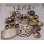 A quantity of silver plate to include candelabra, teasets, trays, condiments and dishes