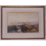 A framed and glazed watercolour of a coastal scene with a lighthouse in the distance, indistinctly