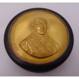 A 19th century circular tortoiseshell and inlaid embossed gold plated snuff box