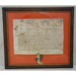 An early framed and glazed vellum indenture with original seal, frame dimensions 72 x 82cm