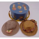 A Victorian hat box of cylindrical form with pull off cover to reveal two ladies garden hats