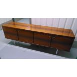 A Danish 1960s rectangular Rosewood sideboard with three cupboards and drawers on four tubular legs,