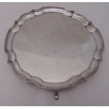 A hallmarked silver salver, Chippendale border with presentation engravings on four scroll feet,
