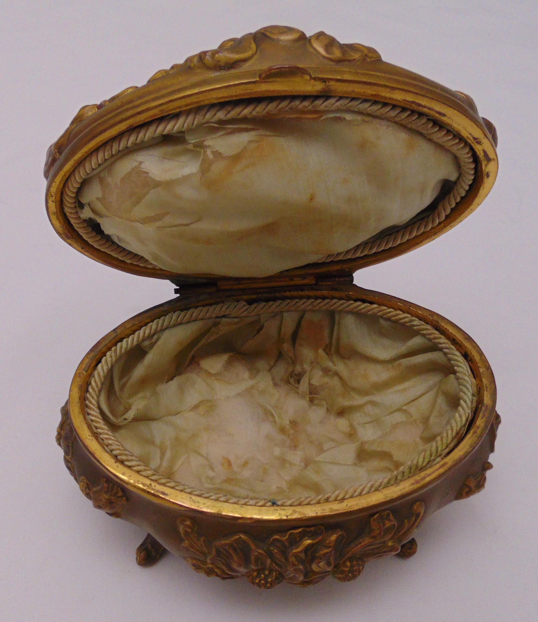 An oval gilt metal jewellery casket with hinged cover on four scroll feet, 12 x 14 x 11cm - Image 2 of 2