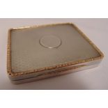 A hallmarked silver and gilt card case, rounded rectangular, engine turned with hinged cover,