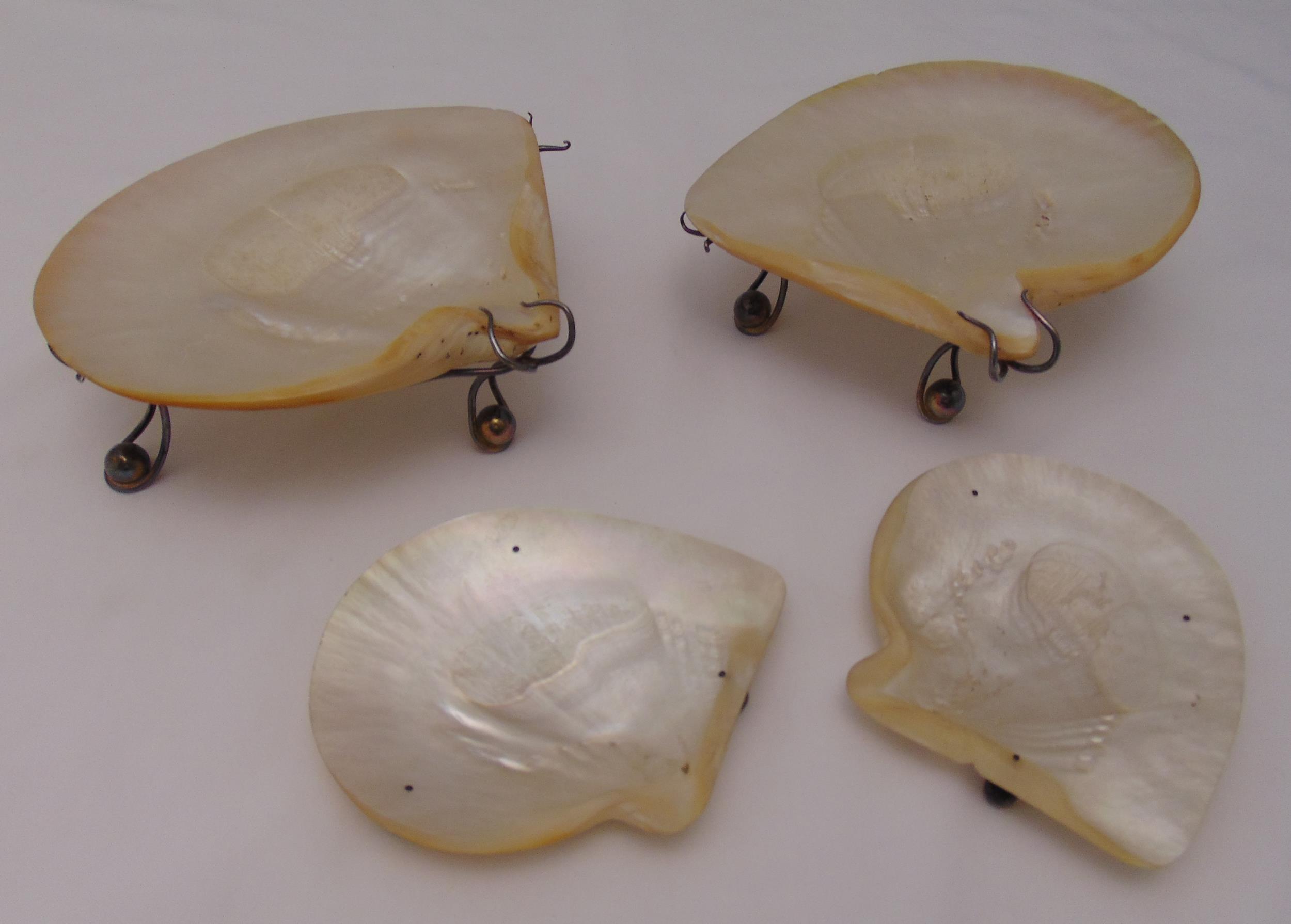 A pair Victorian mother of pearl dishes on stands and another pair on three ball feet