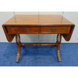 A mahogany rectangular two drawer sofa table with drop flaps on original castors, 74 x 148.5 x 54.