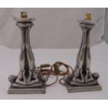 A pair of Art Deco style metal lamp stands in the form of naked flapper girls with raised legs on