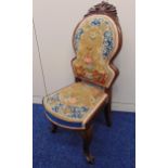 A mahogany childs chair with embroidered seat and back on cabriole legs