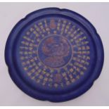 A Chinese sacrificial blue ground dish with scalloped edges decorated with a stylised bird and
