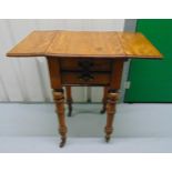 A Victorian rectangular mahogany drop flap occasional table with two drawers and cylindrical legs on
